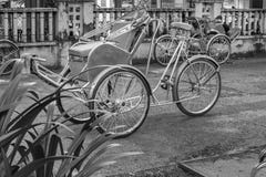 Ho Chi Minh City, Vietnam - September 1, 2018: Vietnamese cyclos and the shape of an undefined man in the back taking a break whil stock photo Ho Chi Minh City, Vietnam - September 1, 2018: Vietnamese cyclos and the shape of an undefined man in the back taking a break whil stock photo