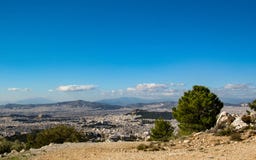 Cityscape of Athens city from Mount Hymettus with white buildings architecture, mountain, trees and blue sky stock image Cityscape of Athens city from Mount Hymettus with white buildings architecture, mountain, trees and blue sky stock image