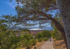 View from the Citadel of Saint-Tropez to the path leading to the sea and the city. On the path in the distance a young couple royalty free stock photos View from the Citadel of Saint-Tropez to the path leading to the sea and the city. On the path in the distance a young couple royalty free stock photos