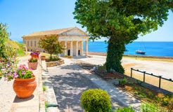 View on classical Greek temple Saint George church architecture of Greece Corfu island capital Kerkyra. Classic yacht. Greece holi royalty free stock image View on classical Greek temple Saint George church architecture of Greece Corfu island capital Kerkyra. Classic yacht. Greece holi royalty free stock image