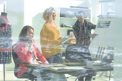 View through the glass wall. a group of fashion designers discussing new ideas royalty free stock photos View through the glass wall. a group of fashion designers discussing new ideas royalty free stock photos