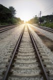 View of the length of railway with green tree at left and right side of railway,filtered image, light effect added stock photography View of the length of railway with green tree at left and right side of railway,filtered image, light effect added stock photography