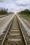 View of the length of railway with green tree at left and right side of railway.filtered image.light effect and flare added royalty free stock photography View of the length of railway with green tree at left and right side of railway.filtered image.light effect and flare added royalty free stock photography