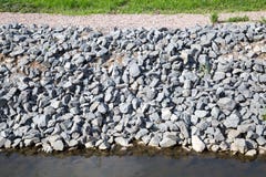 View of the protection of the coast of gray granite stones. stock photography View of the protection of the coast of gray granite stones. stock photography