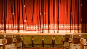 View from within a theater with stage chairs and red curtain stock photography View from within a theater with stage chairs and red curtain stock photography
