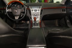 View to the interior of Cadillac CTS with dashboard, clock, media system, front seats and shiftgear after cleaning before sale on stock photos View to the interior of Cadillac CTS with dashboard, clock, media system, front seats and shiftgear after cleaning before sale on stock photos