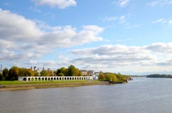 View of the Volkhov River, the city behind the river and the old Gostiny Dvor on a sunny autumn day. Veliky Novgorod, Russia royalty free stock photography View of the Volkhov River, the city behind the river and the old Gostiny Dvor on a sunny autumn day. Veliky Novgorod, Russia royalty free stock photography
