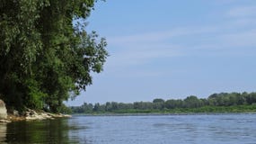 View at a Wild Part of Vistula River in Warsaw with a Man Kayaking in Background Royalty Free Stock Photo View at a Wild Part of Vistula River in Warsaw with a Man Kayaking in Background Royalty Free Stock Photo
