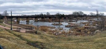 The Big Sioux River flows over rocks in Sioux Falls South Dakota with views of wildlife, ruins, park paths, train track bridge, tr stock photography The Big Sioux River flows over rocks in Sioux Falls South Dakota with views of wildlife, ruins, park paths, train track bridge, tr stock photography