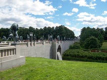 Vigelandsparken, Oslo, Norway in July 2007: picturesque landscape with green lawns and stone bridge in Vigeland Park royalty free stock image Vigelandsparken, Oslo, Norway in July 2007: picturesque landscape with green lawns and stone bridge in Vigeland Park royalty free stock image