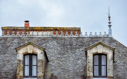 Vindskupefönster kritiserar på taket och orange lampglas Rochefort-en-Terre franska Brittany arkivbild Vindskupefönster kritiserar på taket och orange lampglas Rochefort-en-Terre franska Brittany arkivbild