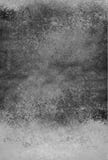 Vintage black and white background with distressed grunge textured wall paint and spattered stain design