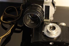Vintage cameras on a mirrored table royalty free stock image Vintage cameras on a mirrored table royalty free stock image