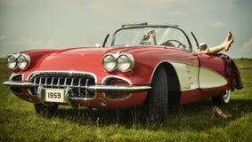Vintage car. Couple having fun on a vintage car Vintage car. Couple having fun on a vintage car