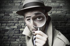 Vintage detective looking through a magnifier royalty free stock photo Vintage detective looking through a magnifier royalty free stock photo