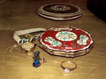 Vintage enamelled puff box, female watches and jewelry. Close up. Nostalgia. Vintage. Memories. Family jewelry. stock photography Vintage enamelled puff box, female watches and jewelry. Close up. Nostalgia. Vintage. Memories. Family jewelry. stock photography