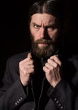 Vintage handsome bearded man. severe man on a dark background. free space for your text stock photo Vintage handsome bearded man. severe man on a dark background. free space for your text stock photo