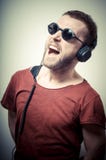 Vintage Portrait Of Fashion Guy With Headphones And Sunglasses Stock Photos
