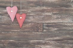 Vintage Red Hearts Hanging over Brown Wooden Background stock photo Vintage Red Hearts Hanging over Brown Wooden Background stock photo