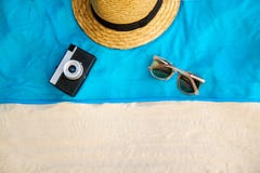 Vintage summer wicker straw beach bag, sun glasses, hat cover-up beachwear wrap on the sand, tropical background stock image Vintage summer wicker straw beach bag, sun glasses, hat cover-up beachwear wrap on the sand, tropical background stock image