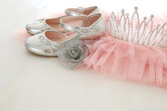 Vintage tulle pink chiffon dress, crown and silver shoes on wooden white floor royalty free stock photography Vintage tulle pink chiffon dress, crown and silver shoes on wooden white floor royalty free stock photography