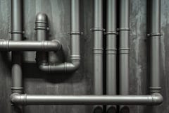 Close up of a wall with pipes. Metallic tubes wall texture. Black barrel and tubing - concept. Silver pipeline system