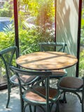 Vintage wooden table set in glass room near the garden royalty free stock image Vintage wooden table set in glass room near the garden royalty free stock image
