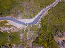 Vista aérea da costa de Córsega, estradas de enrolamento Ciclistas que correm em uma estrada france fotografia de stock Vista aérea da costa de Córsega, estradas de enrolamento Ciclistas que correm em uma estrada france fotografia de stock