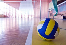 Volleyball in a gym on the floor clouseup