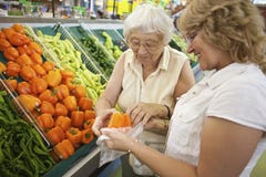 Volunteer helping senior with her shopping