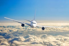 Voo do avião do passageiro a nível do voo alto no céu acima do nascer do sol das nuvens e do céu azul Foto de Stock Voo do avião do passageiro a nível do voo alto no céu acima do nascer do sol das nuvens e do céu azul Foto de Stock