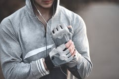 Vor der Anleitung nah oben, setzt Sportkerl Handschuhe auf seine Hände stockfoto Vor der Anleitung nah oben, setzt Sportkerl Handschuhe auf seine Hände stockfoto