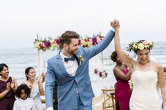 Vrolijke jonggehuwden bij de ceremonie van het strandhuwelijk royalty-vrije stock fotografie Vrolijke jonggehuwden bij de ceremonie van het strandhuwelijk royalty-vrije stock fotografie