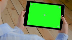 Vrouw die tabletcomputer bekijken met het lege groene scherm - chroma zeer belangrijk concept stock video Vrouw die tabletcomputer bekijken met het lege groene scherm - chroma zeer belangrijk concept stock video