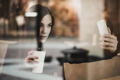 Vrouw met smartphone het drinken koffie royalty-vrije stock afbeeldingen Vrouw met smartphone het drinken koffie royalty-vrije stock afbeeldingen