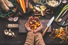 Vrouwelijke vrouwenhanden die gedobbelde kleurrijke groenten op rustieke keukenlijst houden met vegetarische kokende ingrediënten Royalty-vrije Stock Foto Vrouwelijke vrouwenhanden die gedobbelde kleurrijke groenten op rustieke keukenlijst houden met vegetarische kokende ingrediënten Royalty-vrije Stock Foto
