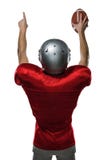 Vue arrière de joueur de football américain avec des bras augmentés image stock Vue arrière de joueur de football américain avec des bras augmentés image stock