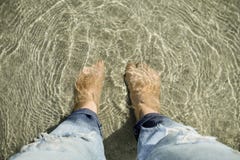 Vue sup?rieure des personnes regardant vers le bas des pieds mis sous le sable et la mer photo libre de droits Vue sup?rieure des personnes regardant vers le bas des pieds mis sous le sable et la mer photo libre de droits