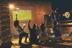 Vänner som håller ögonen på en fotbollsmatch royaltyfri foto Vänner som håller ögonen på en fotbollsmatch royaltyfri foto