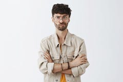 Waist-up shot of intense dissatisfied handsome mature caucasian guy with beard in beige jacket holding hands crossed on stock photos Waist-up shot of intense dissatisfied handsome mature caucasian guy with beard in beige jacket holding hands crossed on stock photos