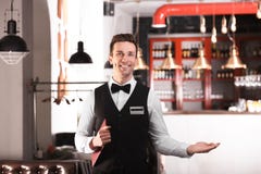 Waiter in elegant uniform with menu Royalty Free Stock Photography Waiter in elegant uniform with menu Royalty Free Stock Photography