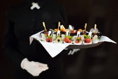 A waiter with a tray of snacks at a banquet royalty free stock photo A waiter with a tray of snacks at a banquet royalty free stock photo