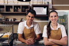Waitress and waiter working at a cafe