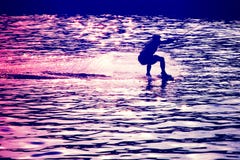 Wakeboarder before jump in rays of setting sun royalty free stock image Wakeboarder before jump in rays of setting sun royalty free stock image