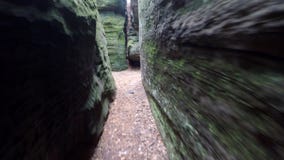 Walk in narrow path in sand rocks corridor like in labyrinth.