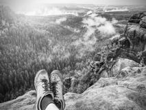 Walking comfortable shoes. All terrain shoes. Hiking boots on hiker Royalty Free Stock Image Walking comfortable shoes. All terrain shoes. Hiking boots on hiker Royalty Free Stock Image