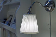 Wall lamp with white shade in the living room interior royalty free stock photography Wall lamp with white shade in the living room interior royalty free stock photography