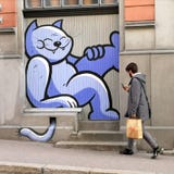 Wall-painted Cat Laughs At Walking Pedestrian