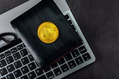 Wallet over keyboard bitcoin out of crypto currency. New digitall symbol of a new virtual currency royalty free stock image Wallet over keyboard bitcoin out of crypto currency. New digitall symbol of a new virtual currency royalty free stock image