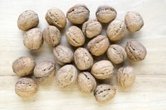 Walnuts in hard shells, pile on wooden background, fruits in hard shells stock photos Walnuts in hard shells, pile on wooden background, fruits in hard shells stock photos